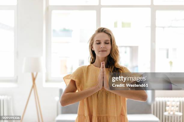 young woman wearing a dress practising yoga - woman active ストックフォトと画像