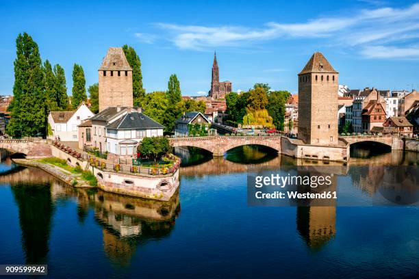 france, strasbourg, the old towers of the city and the cathedral in the background - strasbourg foto e immagini stock