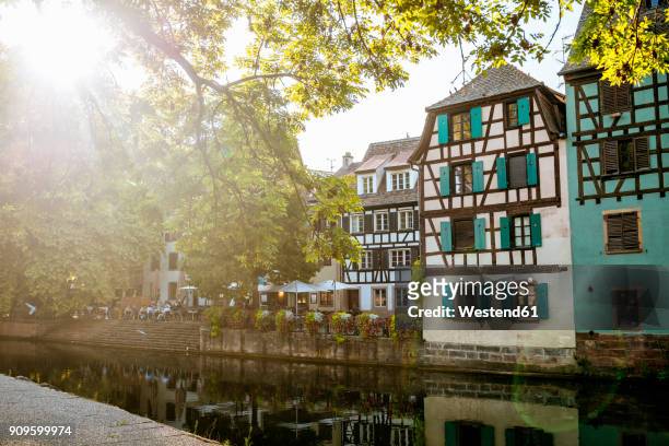 france, strasbourg, half-timbered houses at river iii at sunset - elsass stock-fotos und bilder