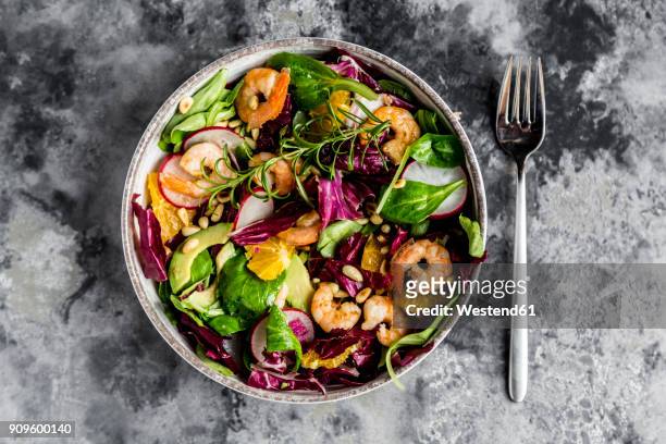 lamb's lettuce, radicchio, shrimp, red radish, orange, pine nut, rosemary, avocado in bowl - salad bowl stock pictures, royalty-free photos & images