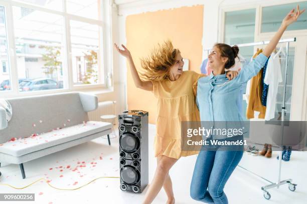 two excited young women having a party - volume 2 stock pictures, royalty-free photos & images