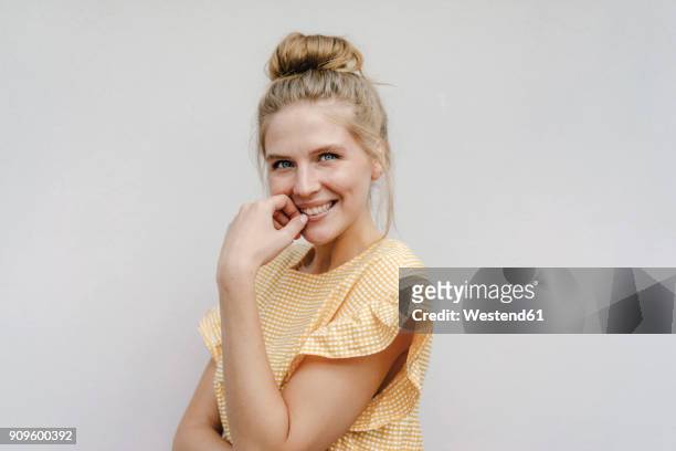 portrait of happy young woman - hair bun stockfoto's en -beelden