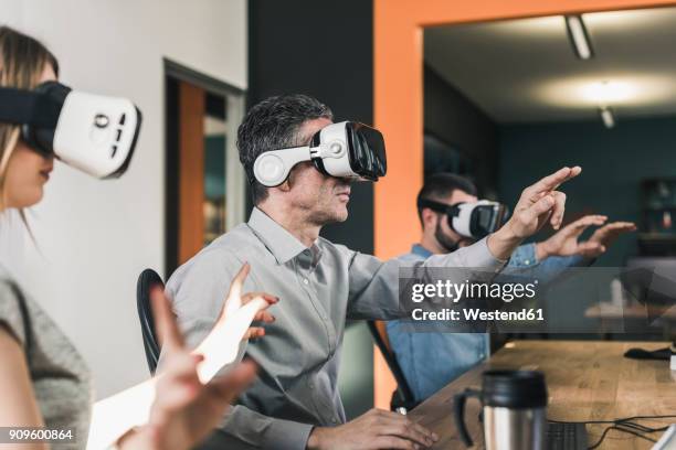 colleagues wearing vr glasses in office - ar glasses stock pictures, royalty-free photos & images