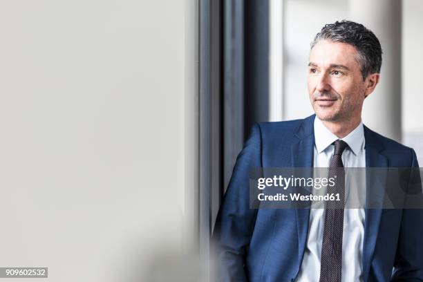 portrait of smiling businessman in office - portrait man suit stock pictures, royalty-free photos & images