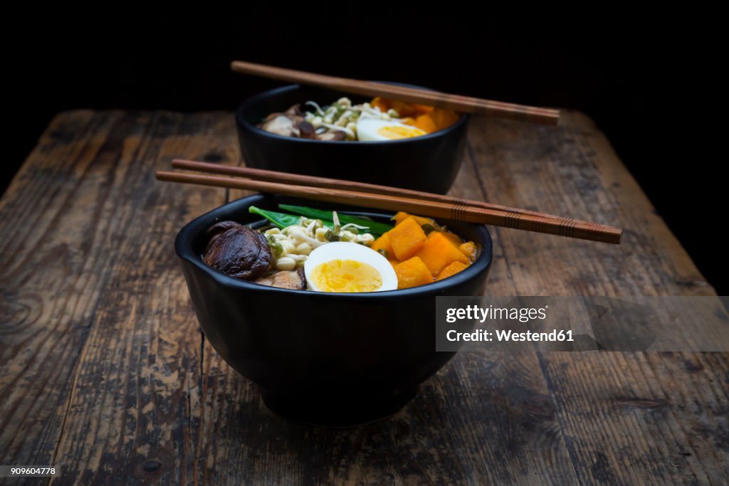 Ramen with noodles, egg, hokkaido pumpkin, mung sprout, shitake mushroom in bowl, chopsticks