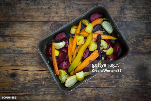 oven winter vegetables, carrot, beetroot, potato and parsnip in roasting tray - winter vegetables stock pictures, royalty-free photos & images