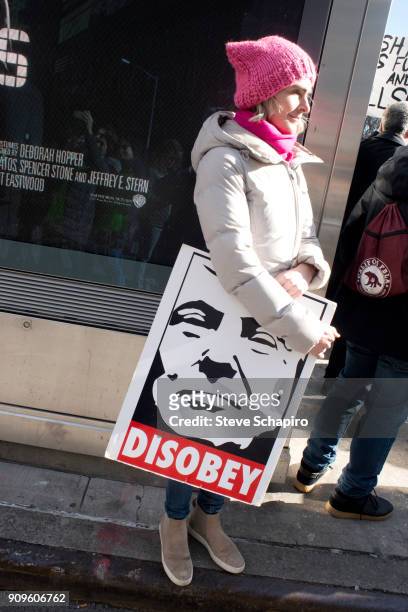View of an unidentified demonstrator at the Women's March on New York, New York, January 20, 2018. She holds a sign that reads 'Disobey' under an...