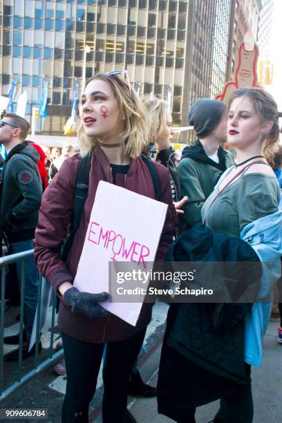 View of unidentified demonstrators at the Women's March on New York, New York, January 20, 2018. One holds a sign that reads 'Empower.'