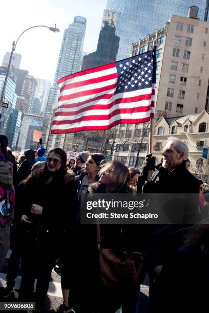 View of demonstrators, one with a large American flag, at the Women's March on New York, New York, January 20, 2018.
