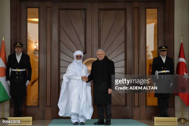 Turkish Prime Minister Binali Yildirim shakes hand with Nigerian Prime minister Brigi Rafini during an official welcome ceremony at Cankaya Palace in...