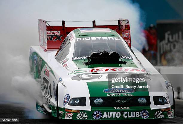 Ashley Force Hood heats her tires during first round qualifying for the NHRA Carolinas Nationals on September 18, 2009 at Zmax Dragway in Concord,...
