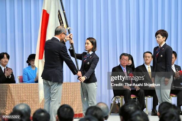 Ski jumper Sara Takanashi receives the national flag during the PyeongChang Winter Olympic Japan Team sending off ceremony at the Ota City General...