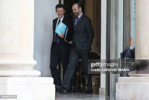 French Prime Minister Edouard Philippe shares a laught with French Government's Spokesperson Benjamin Griveaux as they leave the Elysee presidential...