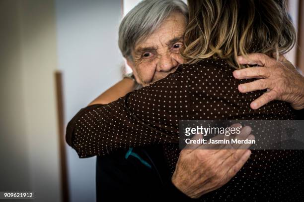 taking care of elderly people - mother daughter holding hands stock pictures, royalty-free photos & images