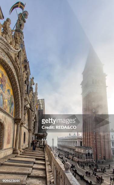 San Marco bell tower in the morning mist. From Basilica di San Marco and square. Venice. Veneto. Italy. Europe.