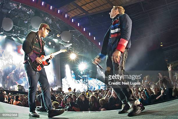 Jonny Buckland and Chris Martin of Colplay perform on stage at Wembley Stadium on September 18, 2009 in London, England.