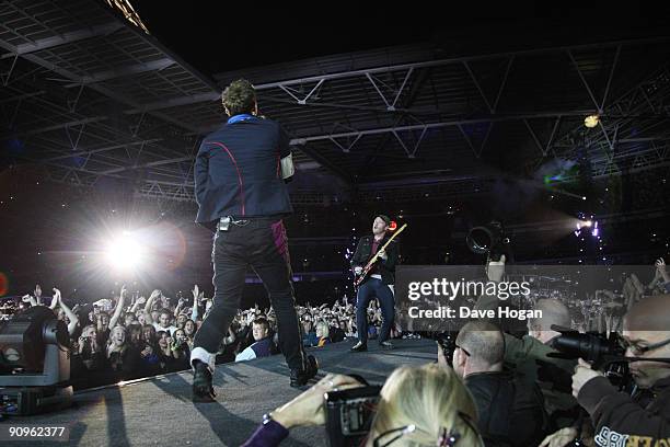 Chris MArtin and Jonny Buckland of Coldplay performs at Wembley Stadium as part of the 'Viva la Vida' tour on September 18, 2009 in London, England.