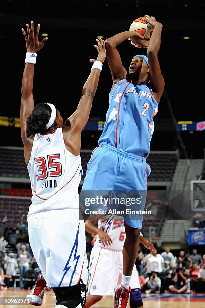 Michelle Snow of the Atlanta Dream goes up for a shot over Cheryl Ford of the Detroit Shock in Game one of the Eastern Conference Semifinals during...