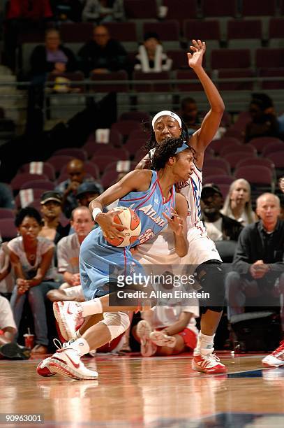 Angel McCoughtry of the Atlanta Dream drives past Alexis Hornbuckle of the Detroit Shock in Game one of the Eastern Conference Semifinals during the...