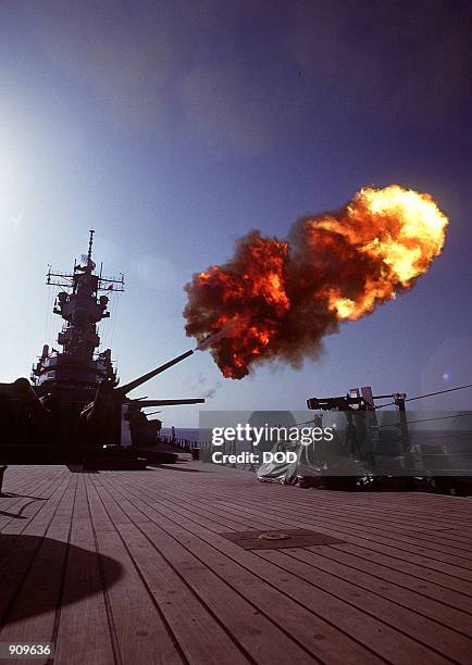 Projectile is fired from a Mark 7 16-inch/50-caliber gun in the No. 2 turret aboard the battleship USS WISCONSIN as gunnery exercises are conducted...