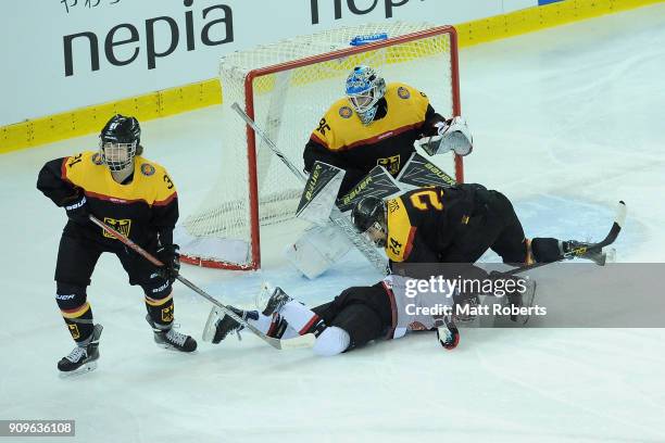 Sena Suzuki of Japan and Kelsey Soccio of Germany battle for the puck during the Women's Ice Hockey International Friendly between Japan v Germany on...