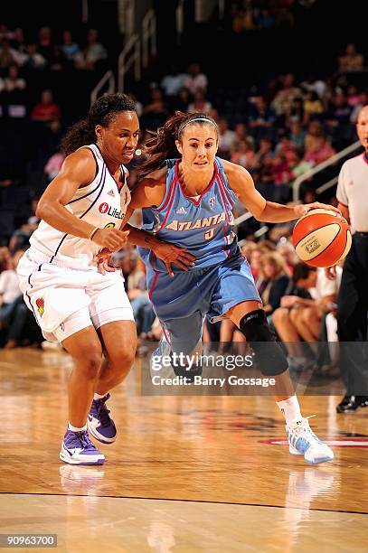 Shalee Lehning of the Atlanta Dream drives the ball up court against Temeka Johnson of the Phoenix Mercury during the WNBA game on September 5, 2009...