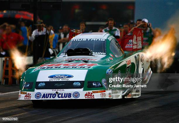 John Force, driver of the Castrol GTX High Mileage Ford drives during second round qualifying for the NHRA Carolinas Nationals on September 18, 2009...