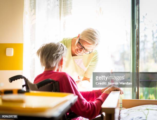Taking care of elderly sick woman in wheelchair
