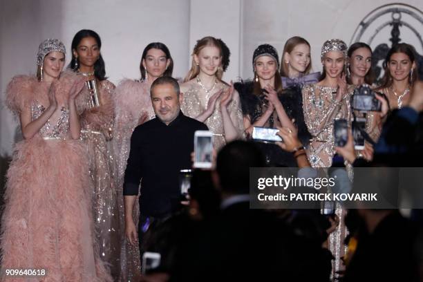 Lebanese fashion designer Elie Saab acknowledges the audience at the end of the 2018 spring/summer Haute Couture collection fashion show on January...