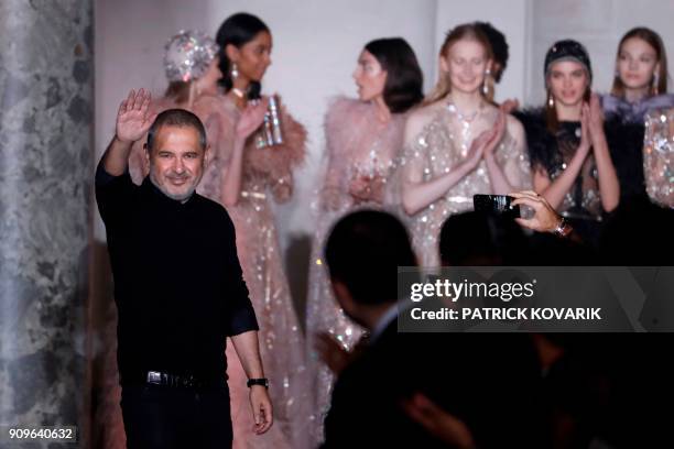 Lebanese fashion designer Elie Saab acknowledges the audience at the end of the 2018 spring/summer Haute Couture collection fashion show on January...