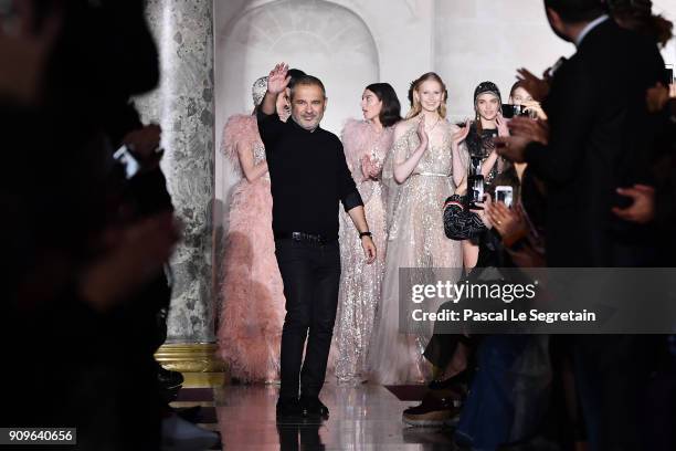 Elie Saab aknwoledges applause on the runway during the Elie Saab Spring Summer 2018 show as part of Paris Fashion Week on January 24, 2018 in Paris,...