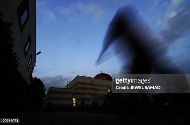 Muslim devotee rushs to pray after breaking fast at the MCC mosque during holy fasting month of Ramadan in Silver Spring, Maryland on September 18,...