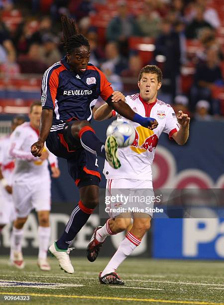 Luke Sassano of the New York Red Bulls battles for the ball against Shalrie Joseph of the New England Revolution at Giants Stadium in the Meadowlands...