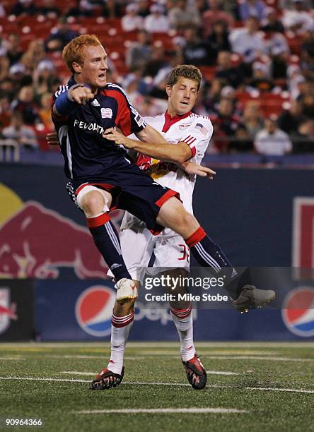 Luke Sassano of the New York Red Bulls and Jeff Larentowicz of the New England Revolution get tangled up at midfield at Giants Stadium in the...