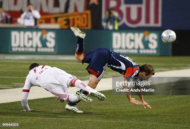 Jeremy Hall of the New York Red Bulls and Steve Ralston of the New England Revolution collide going for a loose ball during their game at Giants...