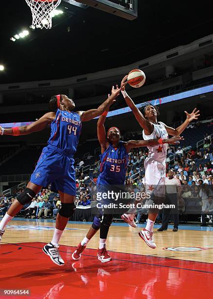 Angel McCoughtry of the Atlanta Dream rebounds during Game Two of the WNBA Eastern Conference Semifinals against Cheryl Ford and Taj McWilliams of...