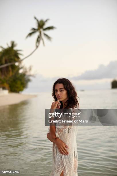 brown haired girl standing wearing beachwear stands in tropical ocean and stares intently at camera - territorios franceses de ultramar fotografías e imágenes de stock