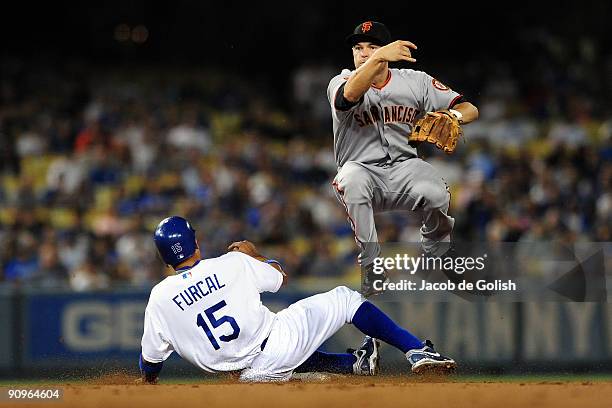 Freddy Sanchez of the San Francisco Giants throws to first base Rafeal Frucal of the Los Angeles Dodgers on a double play in the first inning on...