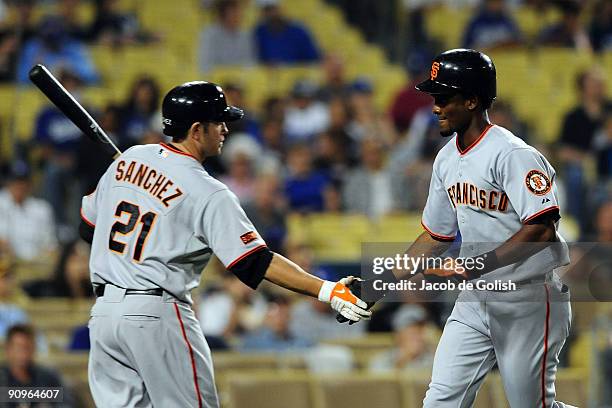 Eugenio Velez of the San Fransico Giants celebrates with Freddy Sanchez after he hits a home run in the first inning against the Los Angeles Dodgers...