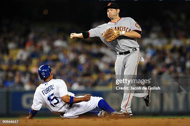Freddy Sanchez of the San Francisco Giants throws over Rafeal Frucal of the Los Angeles Dodgers on a double play in the first inning on September 18,...