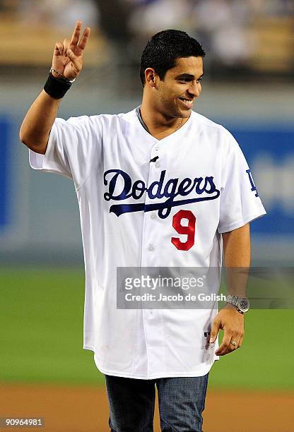 Actor Wilmer Valderrama throws the ceremonial first pitch before a game between the Los Angeles Dodgers and the San Francisco Giants at Dodger...
