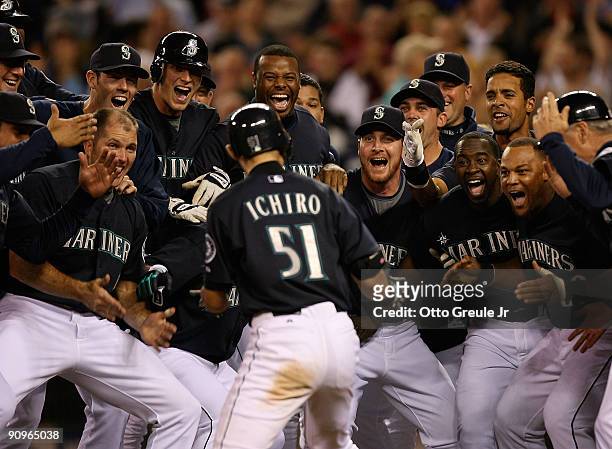 Ichiro Suzuki of the Seattle Mariners is mobbed by teammates after hitting a game winning two-run homer in the bottom of the ninth inning to defeat...