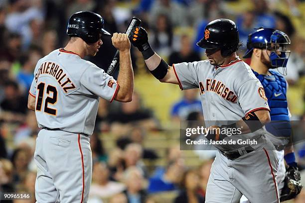 Aaron Rowand of the San Francisco Giants celebrates with teammate Nate Schierholtz after hitting a home run in the eighth inning against the Los...