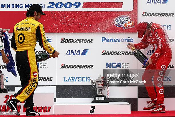 Dario Franchitti, driver of the Target Chip Ganassi Racing Dallara Honda sprays champagne over winner and team mate Scott Dixon, driver of the Target...