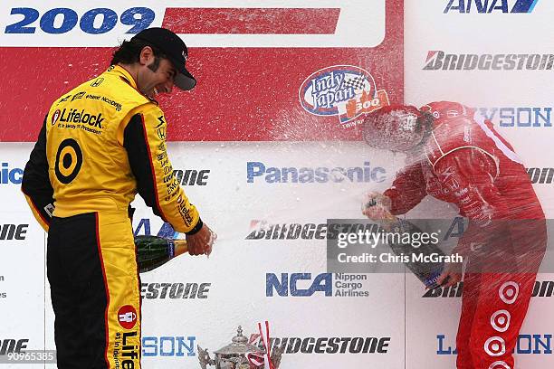 Dario Franchitti, driver of the Target Chip Ganassi Racing Dallara Honda sprays champagne over winner and team mate Scott Dixon, driver of the Target...