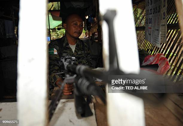 Member of the southern Philippine rebel group, the Moro Islamic Liberation Front , mans an M-60 machine gun at an outpost at Camp Darapanan in the...
