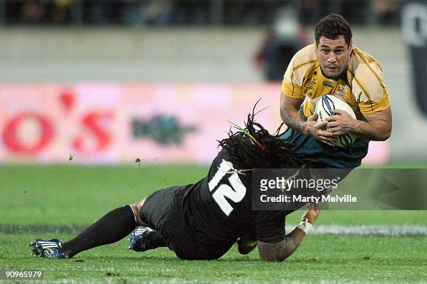 George Smith of the Wallabies is tackled by Ma'a Nonu of the All Blacks during the 2009 Tri Nations series Bledisloe Cup match between the New...