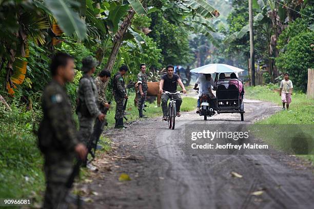 Musilm rebels secure a road inside their camp after Ibrahim Murad, chief of the Moro Islamic Liberation Front, warns anarchy if peace talks between...