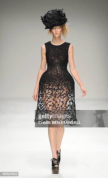 Model presents an outfit by John Rocha for the Spring/Summer 2010 collection on the second day of London Fashion Week, in central London, on...