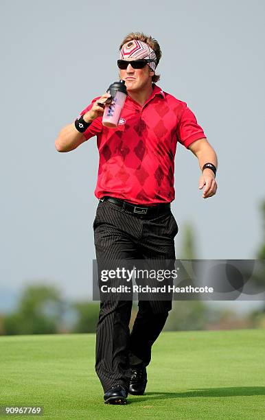 Pelle Edberg of Sweden drinks a protein shake as he walks down the 6th fairway during the third round of the Austrian Golf Open at Fontana Golf Club...